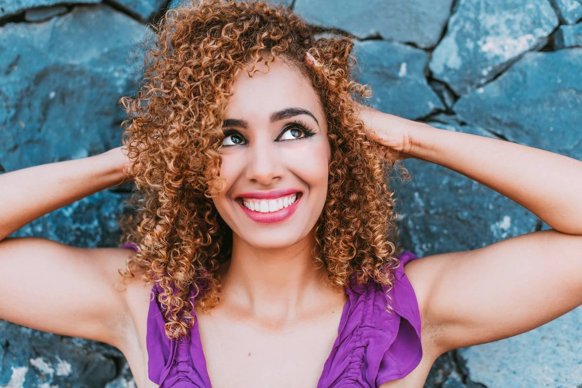 a close up of a person with curly hair